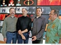 Four guests smile together in front of a vibrant, animated movie-themed wall display at Pixar Pier, capturing the playful and imaginative atmosphere inspired by classic Pixar films during the Steve Jobs era.