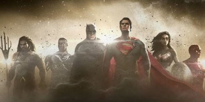 The Justice League’s six legendary superheroes gather on stage in a haze of theatrical smoke, facing the audience with dynamic, heroic stances—ready for action at the heart of your favorite theme park adventure.