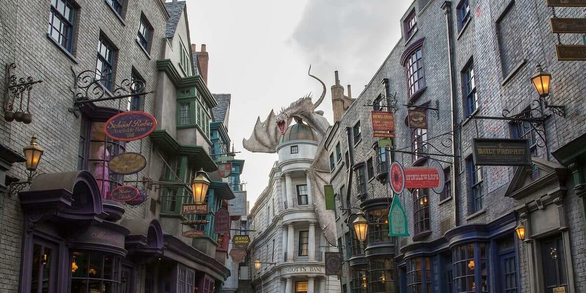 A narrow city street with a building in the rain