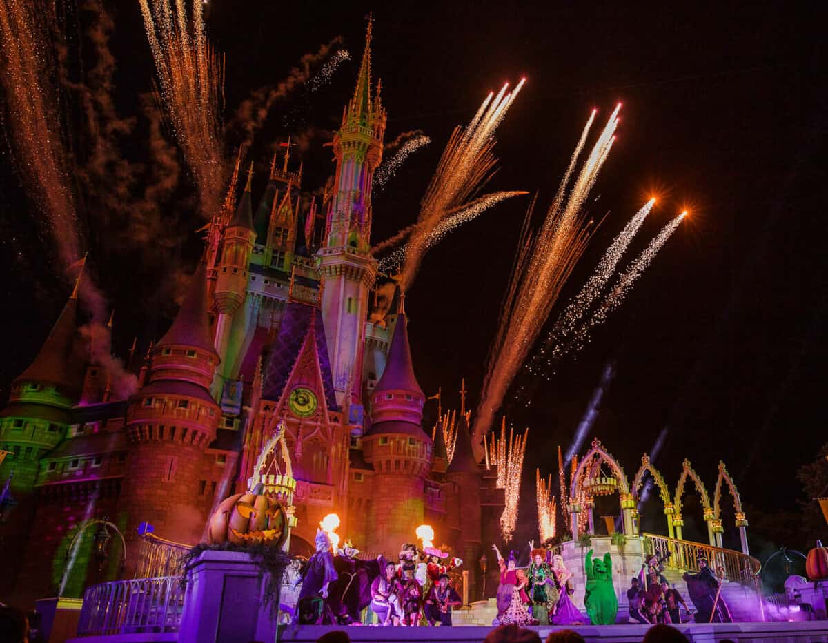 fireworks shooting out from the Cinderella Castle inside Magic Kingdom during mickeys not so scary Halloween party