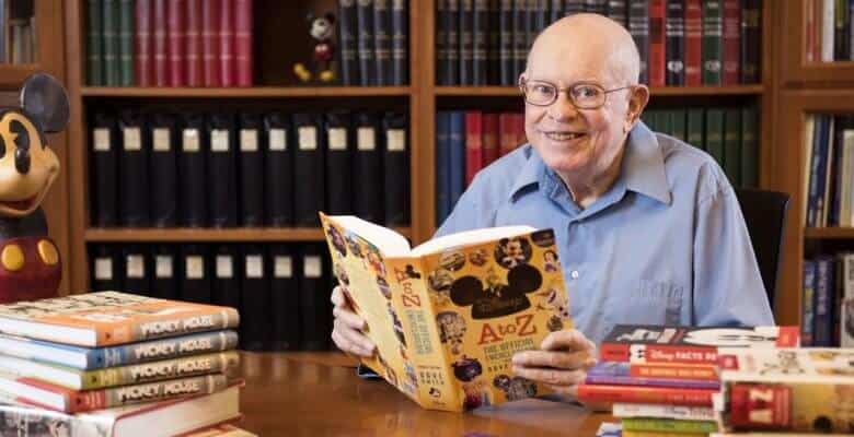 Dave Smith sitting at a table in front of a book shelf