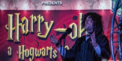 A man in Harry Potter costume performing on stage