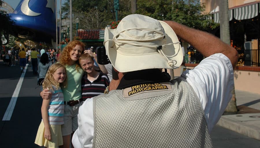PhotoPass Photographer taking a picture ar family