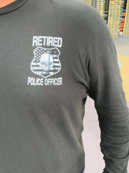 Man wearing Retired Police officer shirt