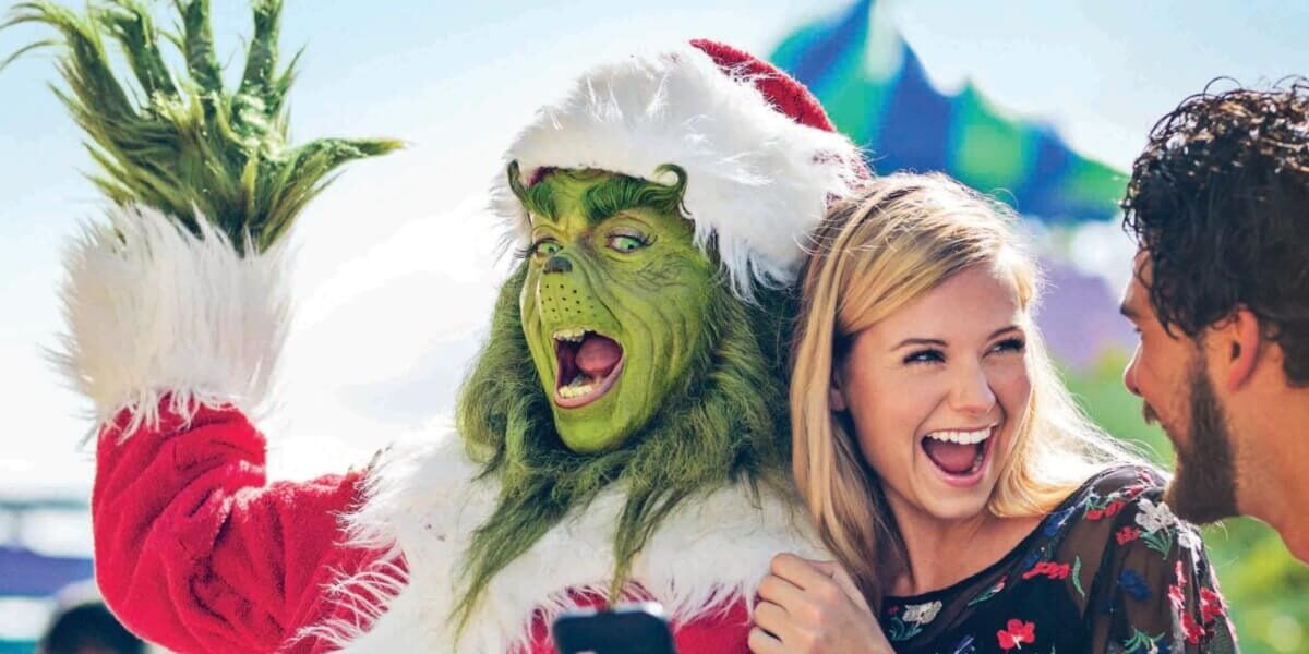 universal orlando resort guests with grinch actor during grinchmas celebration