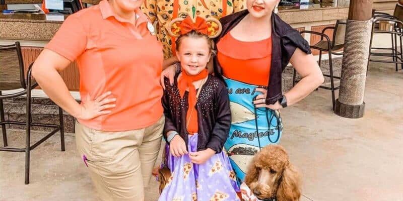 Disney Cast Member and Family posing with Service Dog at Disney Park