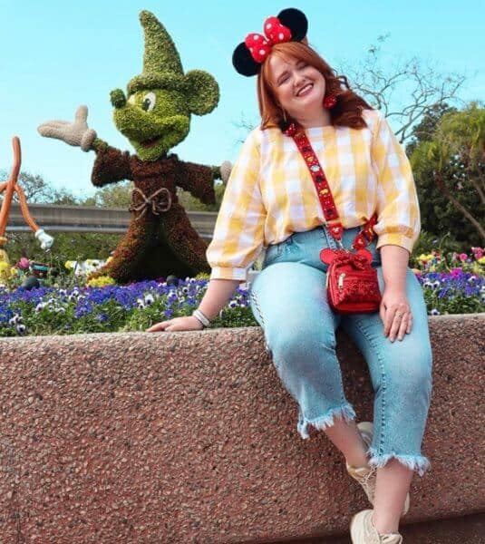 A woman sitting next to Bush Mickey Mouse