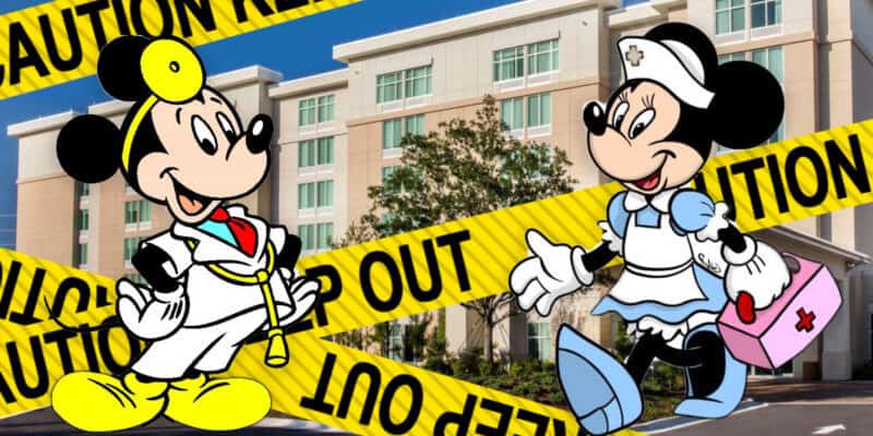 Mickey and Minnie Mouse dressed as doctors with a sign that says Caution keep out