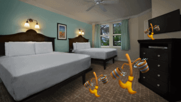 A bedroom with two large beds in a room with two brooms walking with water in pail