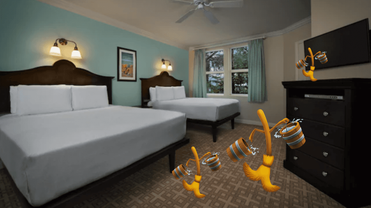 A bedroom with two large beds in a room with two brooms walking with water in pail