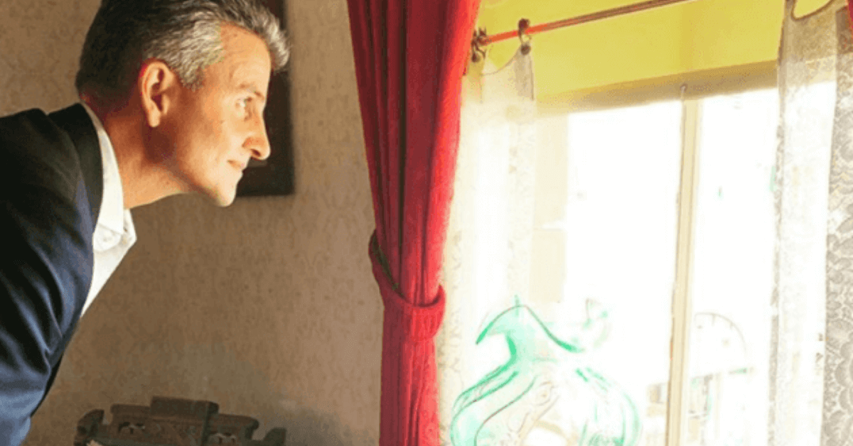 A Man Looking Outside The Window