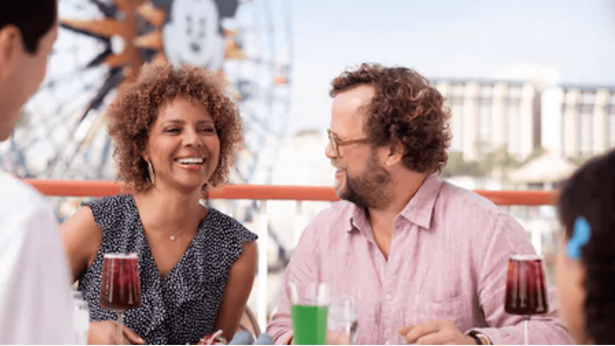 couple dining outdoors near fun wheel at disney california adventure