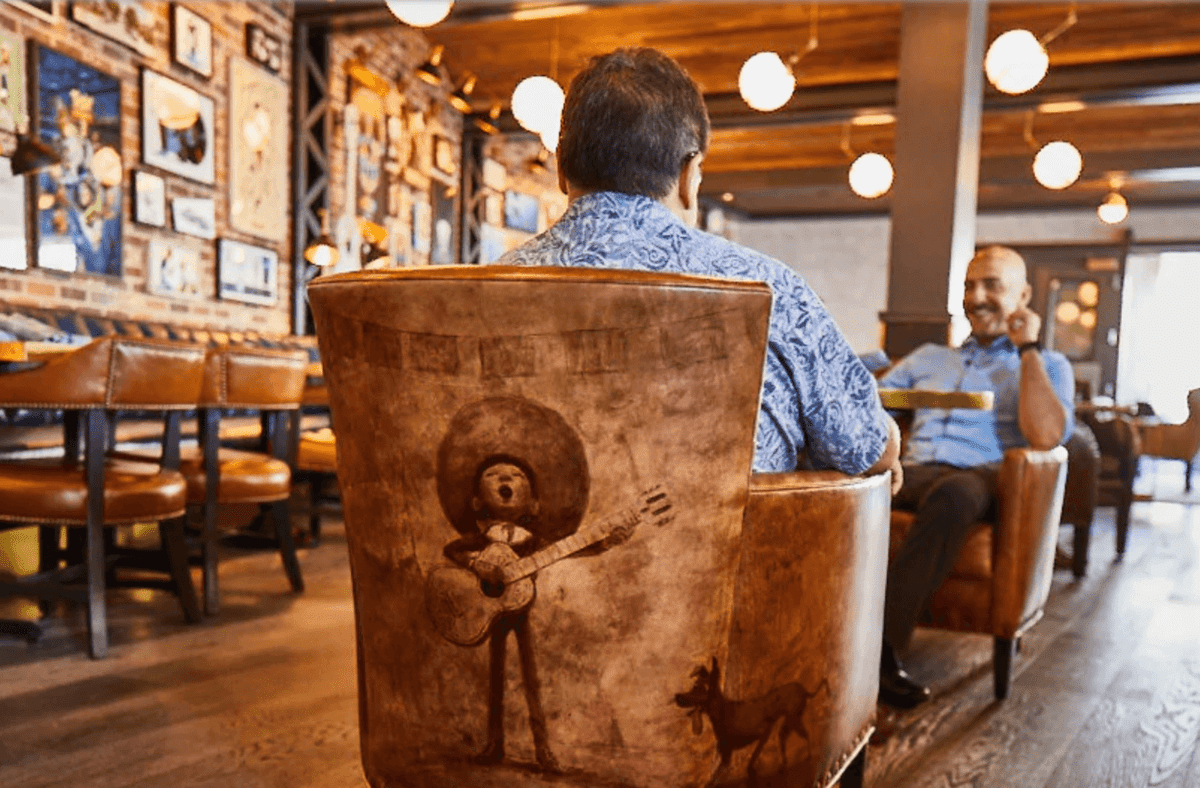 two men dining at lamplight lounge on pixar pier