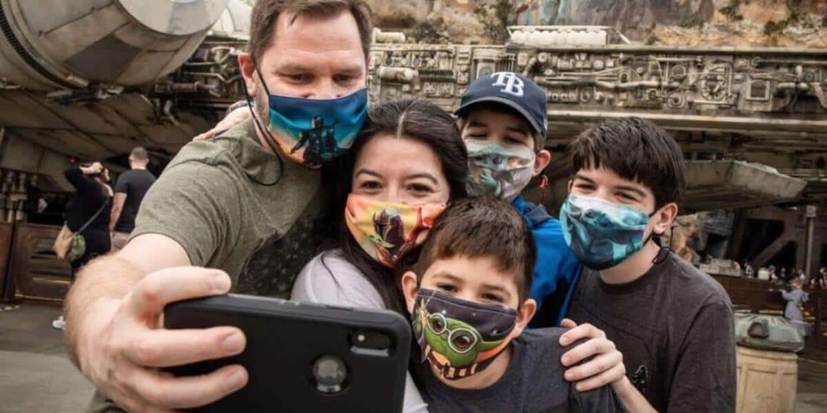 disney world guests take a selfie in galaxy's edge wearing face masks