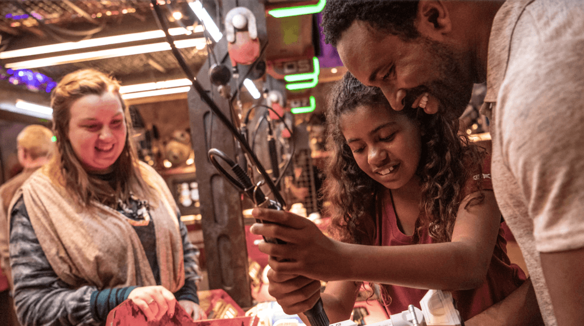 father and daughter at disneyland droid depot