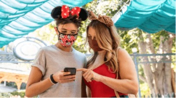 two Guests looking at the Disney App