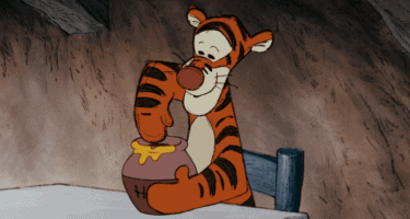 Tigger dipping paw in hunny