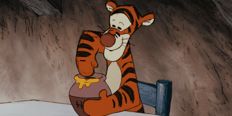 Tigger dipping paw in hunny