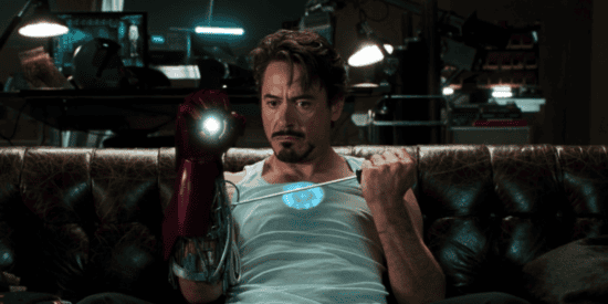 Robert Downey Jr as Iron Man fixing his suit