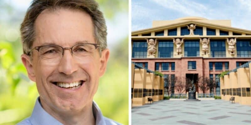 A man wearing glasses and smiling at the camera