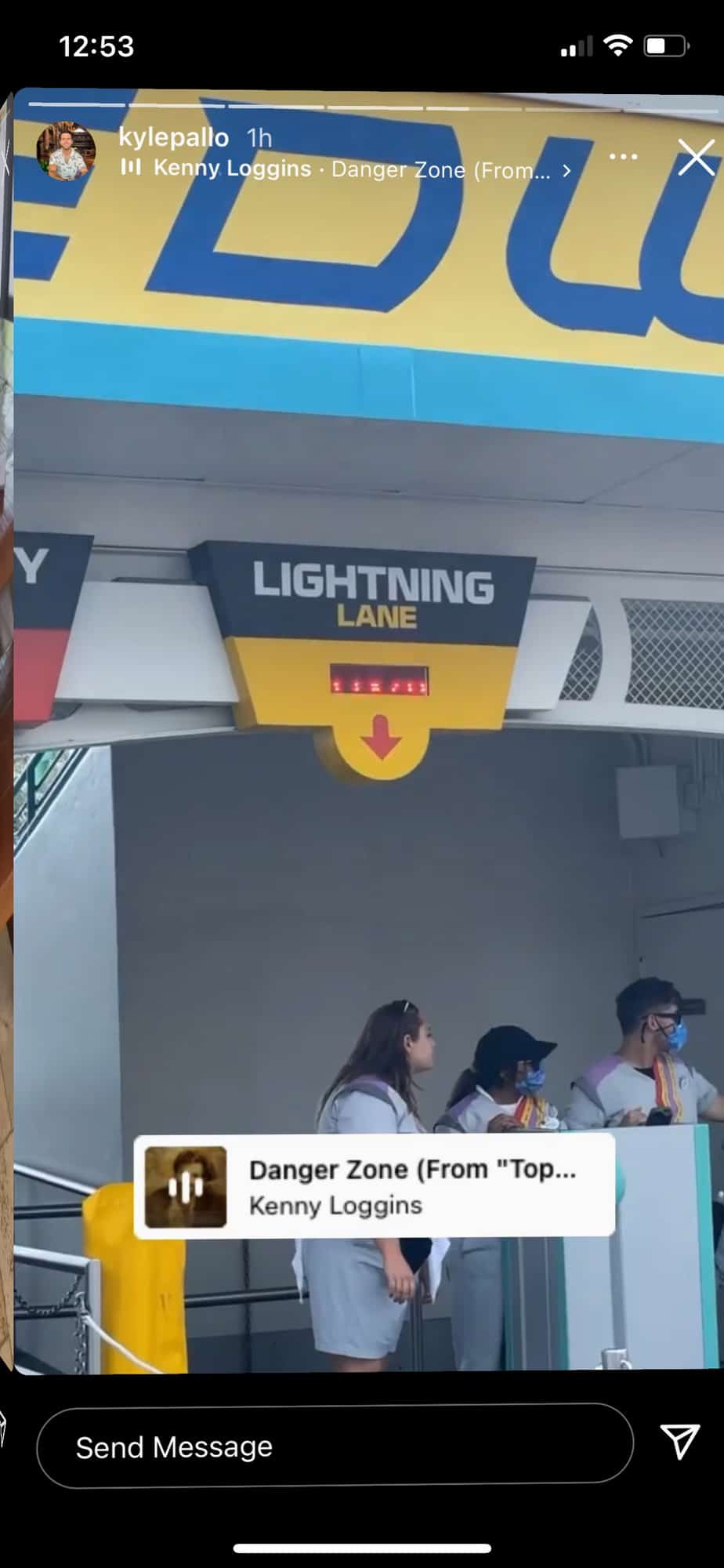 Guests gather at the Lightning Lane entrance in a Disney park, likely taking advantage of Genie+ to skip the standby queues, while “Danger Zone” plays in the background to amp up the excitement.