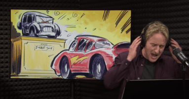 Owen Wilson standing in front of a window