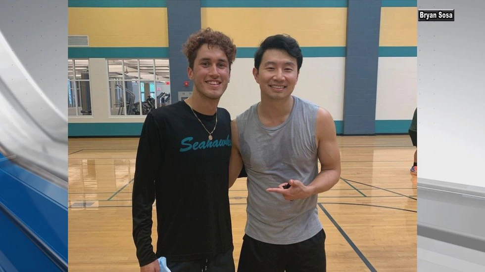 Simu Liu standing posing for the camera