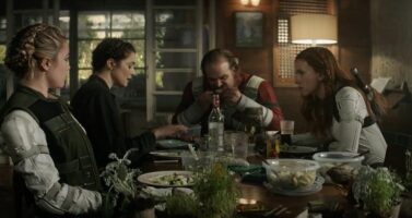 A group of people standing around a table