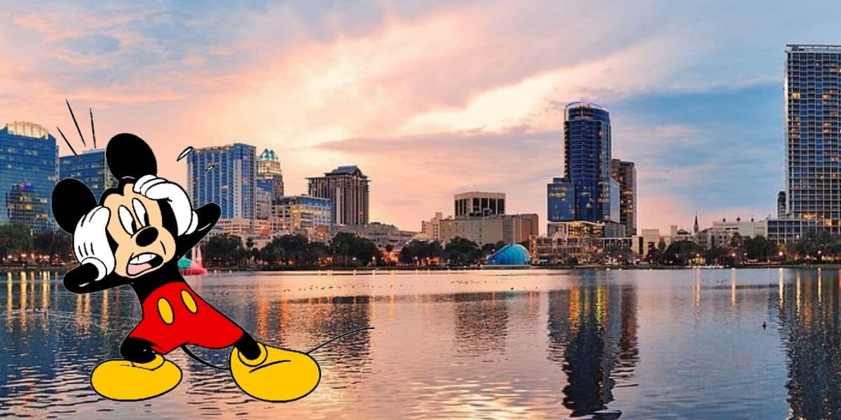 A body of water with a city in the background