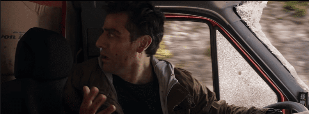 Marc Spector/Steven Grant/Moon Knight in the car driving with a gun in his hand