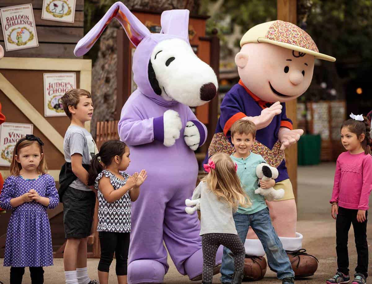 A group of people looking at a teddy bear