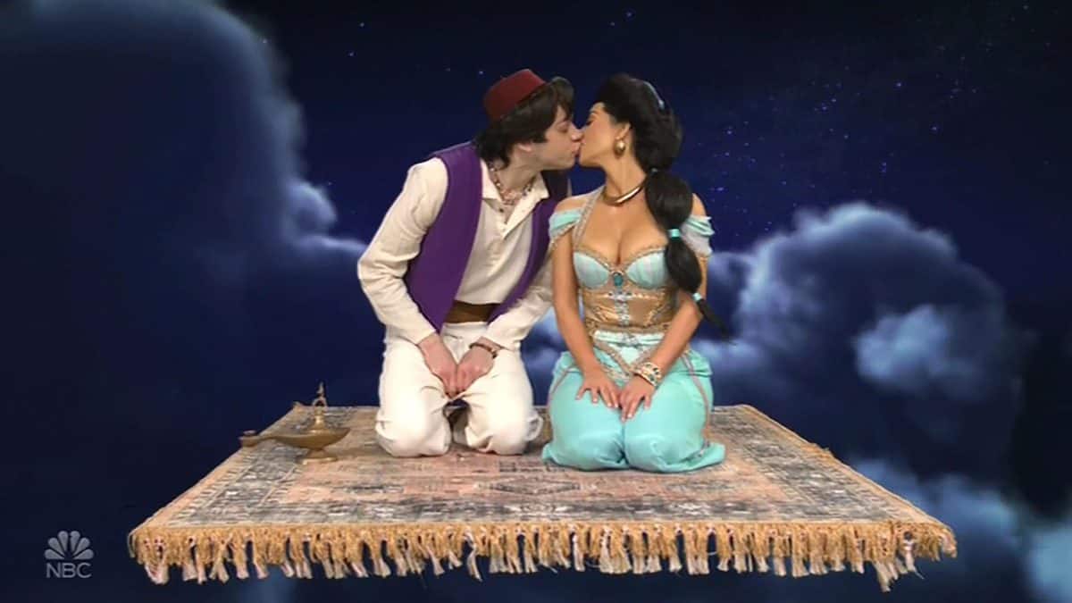 pete davidson (left) and kim kardashian (right) kiss on magic carpet during aladdin skit