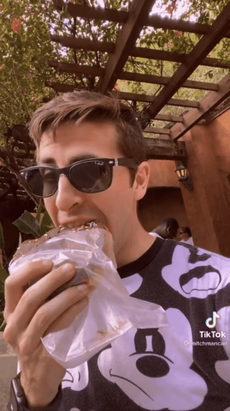 Guest eating a Joffrey Donut