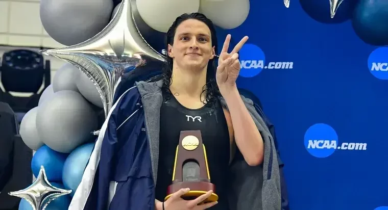 lia thomas with ncaa trophy