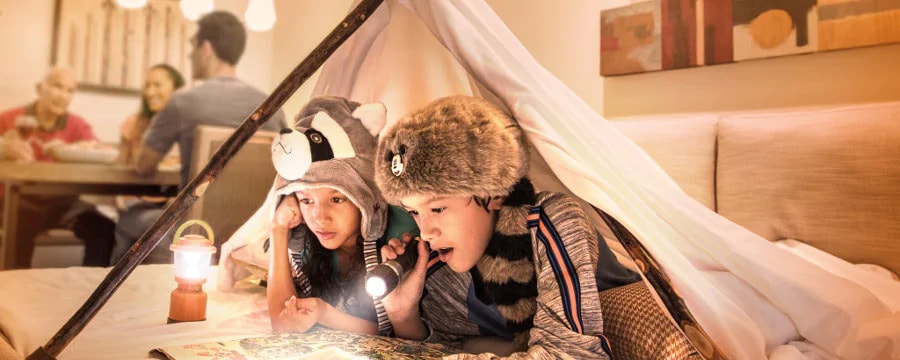 kids reading on bed at disney copper creek dvc villas