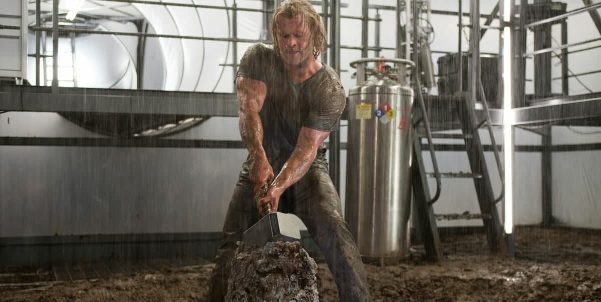 Thor trying to pull stuck Mjolnir out of rock