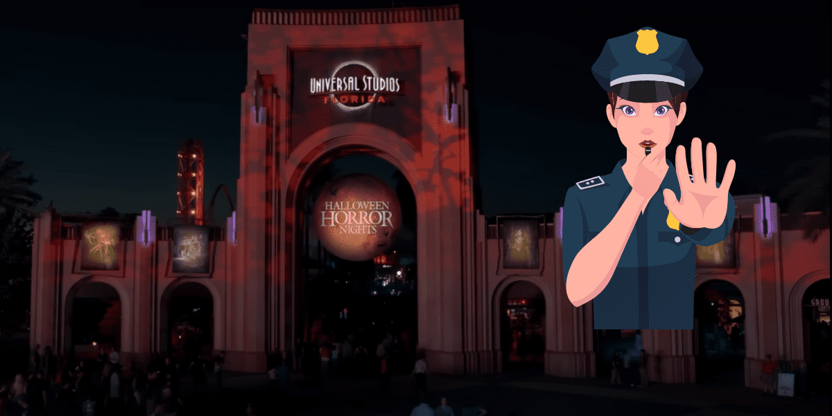 The Universal Studios Florida archway in the dark, with a cartoon drawing of a police officer holding out their hand in a "stop" formation.