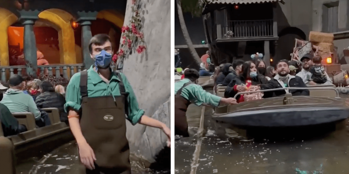 A Cast Member wades through the Pirates water, pushing a boat.