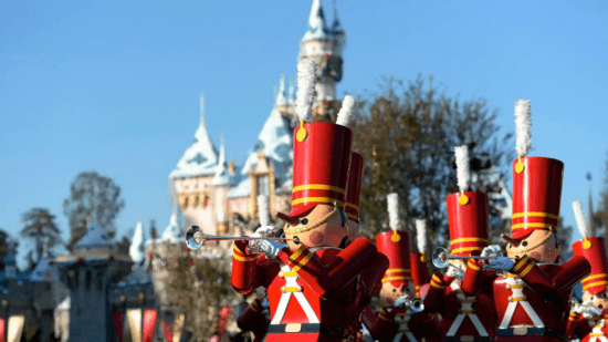 A Christmas Fantasy Parade at disneyland resort with sleeping beauty castle in the background