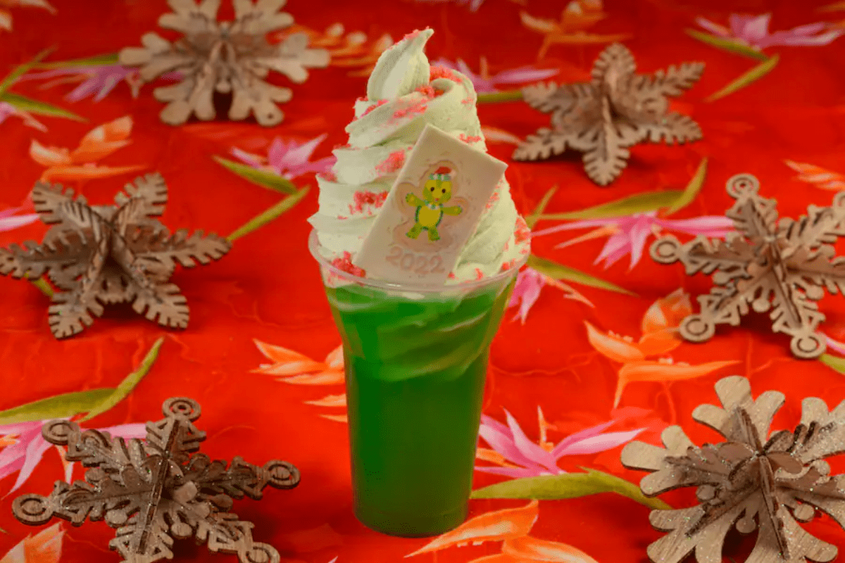 A green drink topped with green dole whip and red POP ROCKS.
