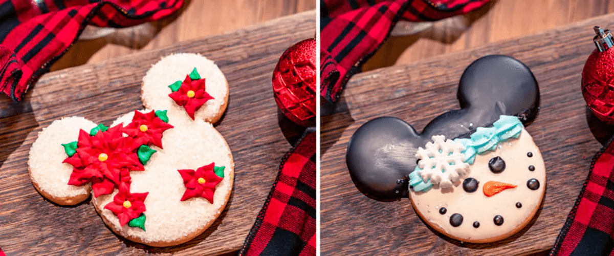 Cookies in the shape of Mickey's head, decorated with red poinsettas and a snowman face.