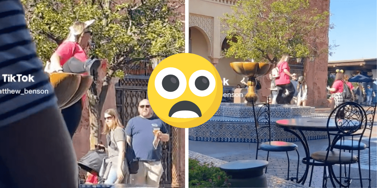 A woman climbing into a fountain at EPCOT.