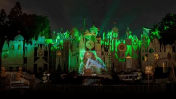 "it's a small world" facade during the Encanto Projection nighttime show playing "We Don't Talk About Bruno