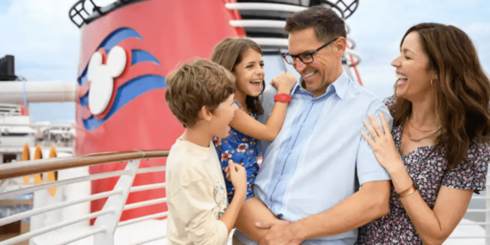 A family standing on the deck of a Disney Cruise Ship