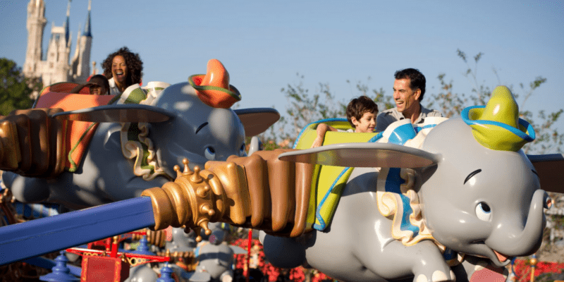 A family riding Dumbo the Flying Elephant at the Magic Kingdom.