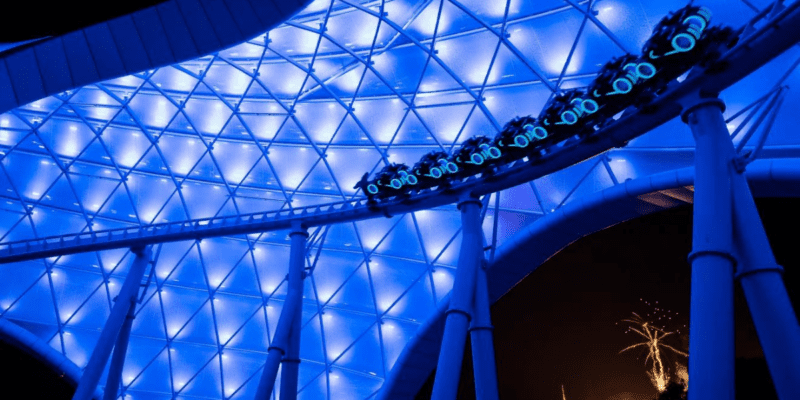 One of the banks on TRON Lightcycle/Run at night with a coaster car on it.