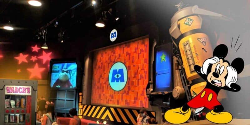 Mickey Mouse shocked in front of the stage of Monster Inc. looking at the snack vending machine.