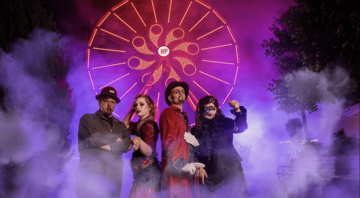 Scareactors standing in front of a ferris wheel at Hersheypark Dark Nights