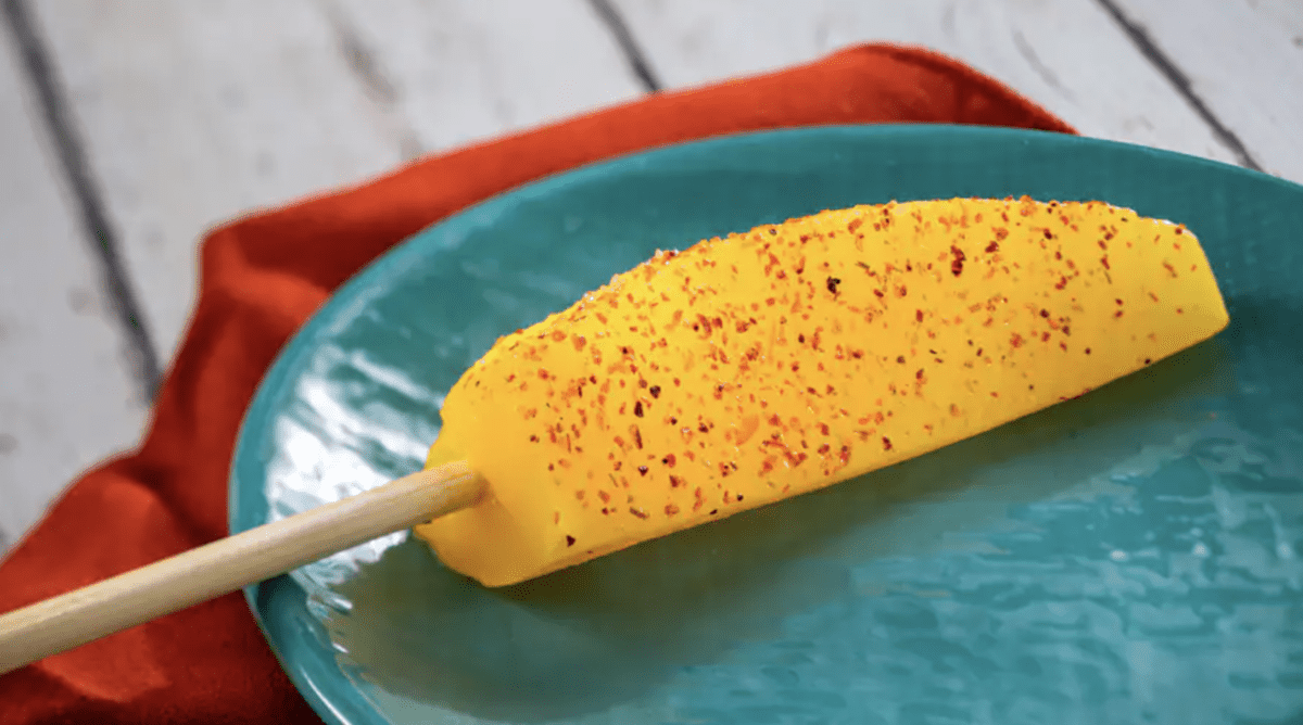 A piece of pineapple with seasoning on it