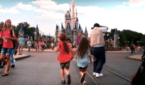 Two girls standing in front of Cinderella Castle in The Florida Project